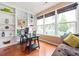 Sun-filled office featuring built-in shelving, a dark wood desk, and hardwood floors at 4306 Laurel Creek Se Ct, Smyrna, GA 30080