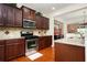 Gourmet kitchen featuring stainless steel appliances, granite countertops, and rich wood cabinetry at 4306 Laurel Creek Se Ct, Smyrna, GA 30080