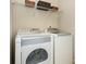 Modern laundry room featuring white, front-load washer and dryer at 4306 Laurel Creek Se Ct, Smyrna, GA 30080