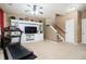 Inviting living room features a ceiling fan, built-in shelves, and staircase at 4306 Laurel Creek Se Ct, Smyrna, GA 30080