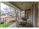 Charming balcony features iron railings and a bench overlooking a landscaped front yard at 4649 Equestrian Way, Atlanta, GA 30338