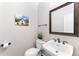 Charming powder room with decorative mirror, stylish sink, and fresh paint at 4649 Equestrian Way, Atlanta, GA 30338