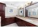 Luxurious bathroom featuring granite countertops, double sinks, and stylish vanity lighting at 4649 Equestrian Way, Atlanta, GA 30338