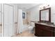 Well-lit bathroom includes a vanity with granite countertop and a shower-tub combination at 4649 Equestrian Way, Atlanta, GA 30338