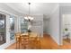 Sunny breakfast nook features hardwood floors, a chandelier and windows with a view at 4649 Equestrian Way, Atlanta, GA 30338