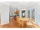 Bright dining area features hardwood floors, modern chandelier, and sliding doors to the screened-in porch at 4649 Equestrian Way, Atlanta, GA 30338