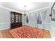 Classic dining room features hardwood floors, a decorative rug, chandelier, and ample natural light at 4649 Equestrian Way, Atlanta, GA 30338