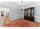 Elegant dining room boasts hardwood floors, modern chandelier, and a classic china cabinet at 4649 Equestrian Way, Atlanta, GA 30338
