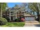 Charming two-story brick home with a well-manicured lawn, a two-car garage, and beautiful landscaping at 4649 Equestrian Way, Atlanta, GA 30338