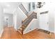 Bright entryway with hardwood floors, stairs with iron spindles, and a soaring ceiling at 4649 Equestrian Way, Atlanta, GA 30338