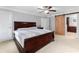 Spacious main bedroom with plush carpet, ceiling fan, and barn door entry to ensuite bathroom at 4649 Equestrian Way, Atlanta, GA 30338