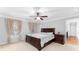 Comfortable bedroom with plush carpeting, ceiling fan, and a large window with natural light at 4649 Equestrian Way, Atlanta, GA 30338