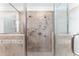 Luxurious shower with glass enclosure, multiple shower heads, and decorative tile accents at 4649 Equestrian Way, Atlanta, GA 30338