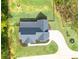 Aerial view of a well-maintained home, lush landscaping, long driveway and fenced-in backyard at 62 Presley Farm Pkwy, Rockmart, GA 30153
