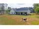 Spacious backyard with a covered patio, fenced yard, and outdoor seating area at 62 Presley Farm Pkwy, Rockmart, GA 30153