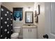 Well-lit bathroom with polka dot shower curtain, granite vanity and decorative artwork at 62 Presley Farm Pkwy, Rockmart, GA 30153