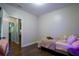 A small bedroom with a single bed, wood floors and multiple doorways at 62 Presley Farm Pkwy, Rockmart, GA 30153