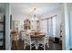 Well-lit dining room with a round table, white chairs, and stylish decor at 62 Presley Farm Pkwy, Rockmart, GA 30153