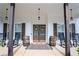 Inviting front porch features rocking chairs, rustic barrel accents, and double front doors with wreath decor at 62 Presley Farm Pkwy, Rockmart, GA 30153