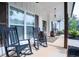 Spacious front porch boasts rocking chairs, rustic barrel accents, and ample space for relaxation and curb appeal at 62 Presley Farm Pkwy, Rockmart, GA 30153