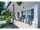 Charming front porch with rocking chairs, barrel accents, American flag and a welcoming curb appeal at 62 Presley Farm Pkwy, Rockmart, GA 30153