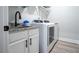 Efficient laundry room featuring modern washer/dryer, granite counters, and storage at 62 Presley Farm Pkwy, Rockmart, GA 30153