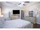 Comfortable main bedroom featuring wood flooring, TV, and decorative furniture at 62 Presley Farm Pkwy, Rockmart, GA 30153