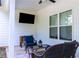 Covered patio with comfortable seating and a mounted TV for outdoor entertainment at 62 Presley Farm Pkwy, Rockmart, GA 30153