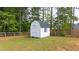 White backyard shed with a window and fenced in yard at 62 Presley Farm Pkwy, Rockmart, GA 30153