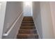 Carpeted staircase with white railing leading to upper level; light and neutral color palette at 62 Presley Farm Pkwy, Rockmart, GA 30153