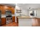 Kitchen with stainless steel appliances, wooden cabinets, granite countertops, and an open layout at 821 Ralph Mcgill Ne Blvd # 2113, Atlanta, GA 30306