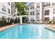 Resort-style pool surrounded by modern buildings, trees, and stylish poolside seating at 821 Ralph Mcgill Ne Blvd # 2113, Atlanta, GA 30306