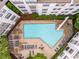 Aerial view shows a modern pool and deck area surrounded by the building's architectural design and lush greenery at 821 Ralph Mcgill Ne Blvd # 2113, Atlanta, GA 30306
