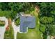 Aerial shot shows a home with a paved driveway and a lush green surrounding landscape with mature trees at 2334 Fisher Dr, Loganville, GA 30052
