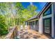 Relaxing outdoor deck overlooking a green forest, complete with lounge chairs for enjoying the natural landscape at 2334 Fisher Dr, Loganville, GA 30052
