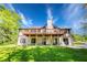 Expansive back of house with beautiful lawn and hanging hammocks below a large upper deck, perfect for relaxing at 2334 Fisher Dr, Loganville, GA 30052