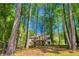 Secluded backyard with a pathway leading to a home with a large deck at 2334 Fisher Dr, Loganville, GA 30052