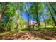Spacious backyard with a pathway leading to a home with a large deck at 2334 Fisher Dr, Loganville, GA 30052