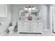 This bathroom features a toilet, double sink with mirrors, and a cabinet at 2334 Fisher Dr, Loganville, GA 30052