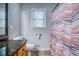 This bathroom features a shower curtain, toilet, and a window at 2334 Fisher Dr, Loganville, GA 30052