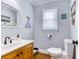 Charming half-bathroom with neutral colors, a wood vanity, and stylish decor at 2334 Fisher Dr, Loganville, GA 30052