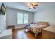 This bedroom features a window, ceiling fan, and hardwood floors at 2334 Fisher Dr, Loganville, GA 30052