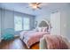 This bedroom features a hanging swing chair, hardwood floors, and a window at 2334 Fisher Dr, Loganville, GA 30052