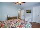 This bedroom features a ceiling fan, hardwood floors, and a wall-mounted TV at 2334 Fisher Dr, Loganville, GA 30052