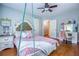 This bedroom features a hanging swing chair, hardwood floors, and a vanity at 2334 Fisher Dr, Loganville, GA 30052