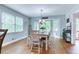 Bright dining area featuring hardwood floors, a bay window, and a table with seating for six at 2334 Fisher Dr, Loganville, GA 30052