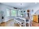 Sunlit dining area with hardwood floors, bay window, and seating for six offers serene views at 2334 Fisher Dr, Loganville, GA 30052