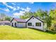 Charming painted brick home featuring black shutters, a new roof, and a well-manicured lawn and landscaping at 2334 Fisher Dr, Loganville, GA 30052