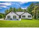 Charming painted brick home featuring black shutters, a new roof, and a well-manicured lawn and landscaping at 2334 Fisher Dr, Loganville, GA 30052