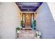Inviting front entrance with brick accents, decorative wreath, and a charming welcome sign for guests at 2334 Fisher Dr, Loganville, GA 30052